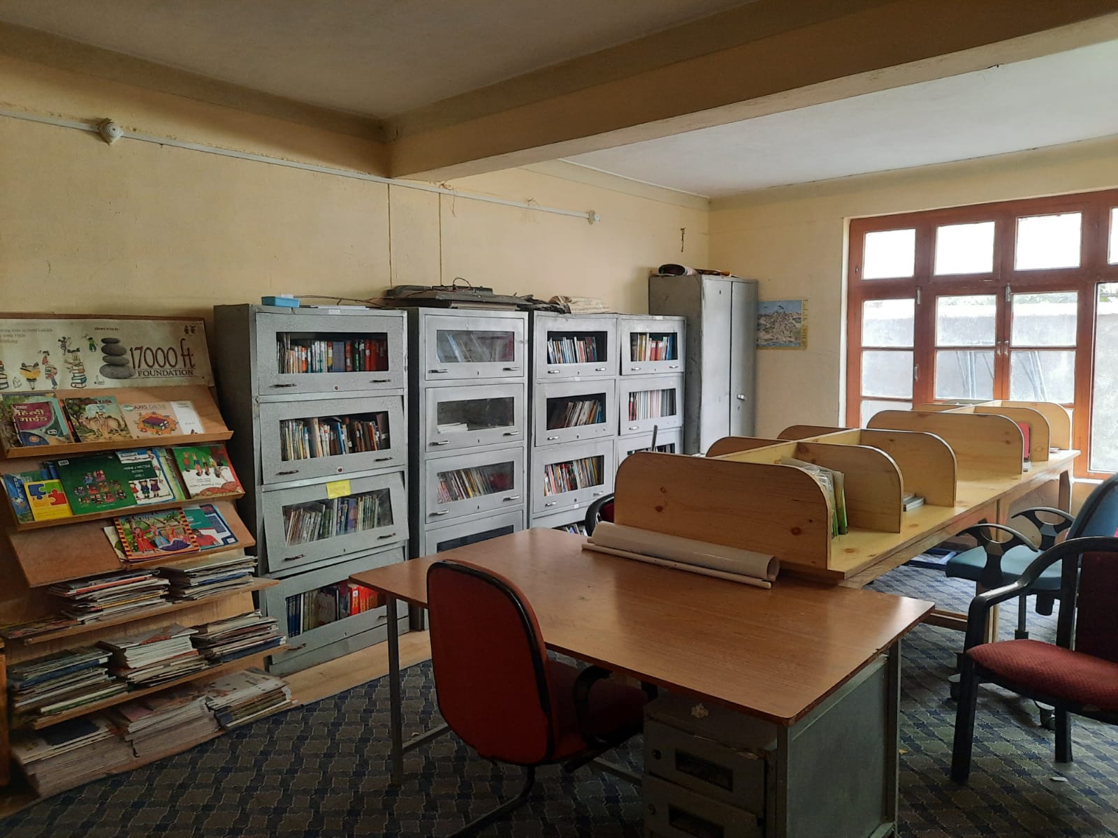 Doorway to the school library with trophies above and reading tables inside