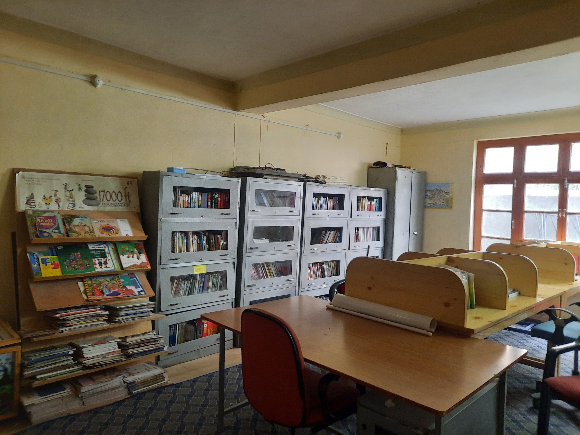 Doorway to the school library with trophies above and reading tables inside